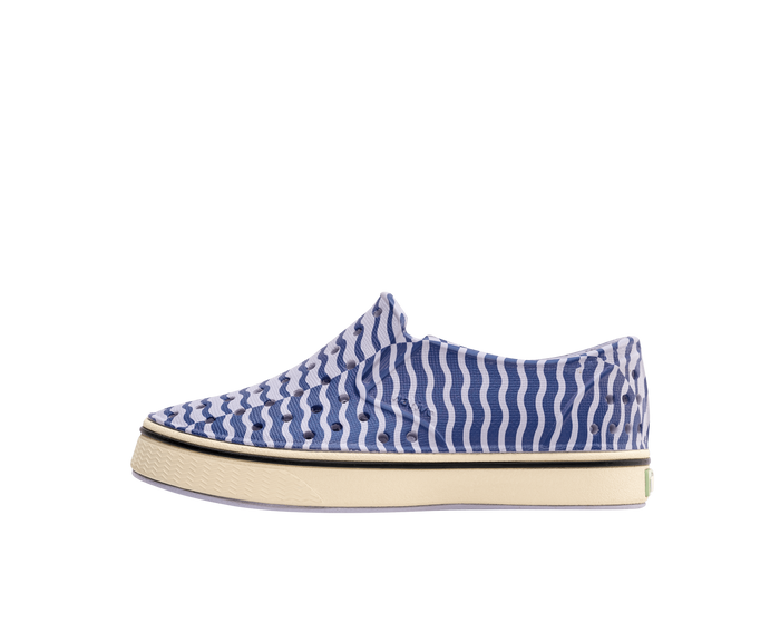 Side view of a Native Shoes Kids Miles Bloom Print Kids Footwear in Future Purple / Bone White / Ink Wiggle Stripe
