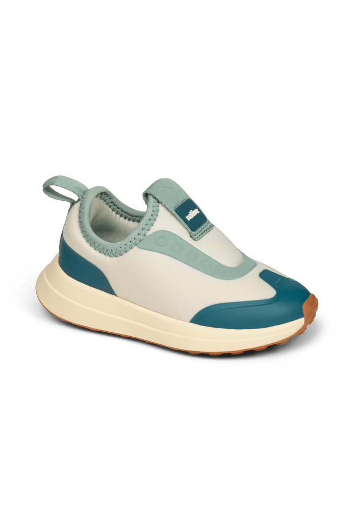 Angled view of a Native Shoes Kids Robbie Dash Kids | Bone White / Tapioca Off White / Hazel Brown Footwear in Bone White / Tapioca Off White / Hazel Brown